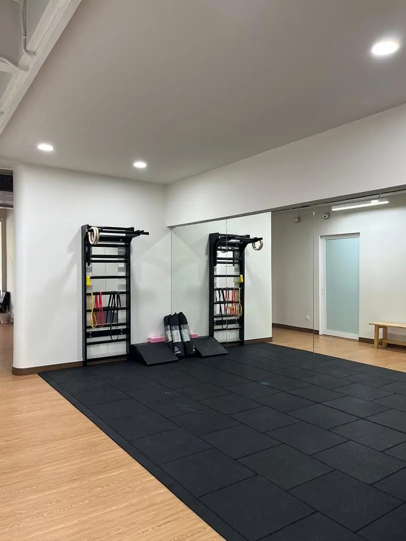 Open rehabilitation studio with mirrors and exercise equipment