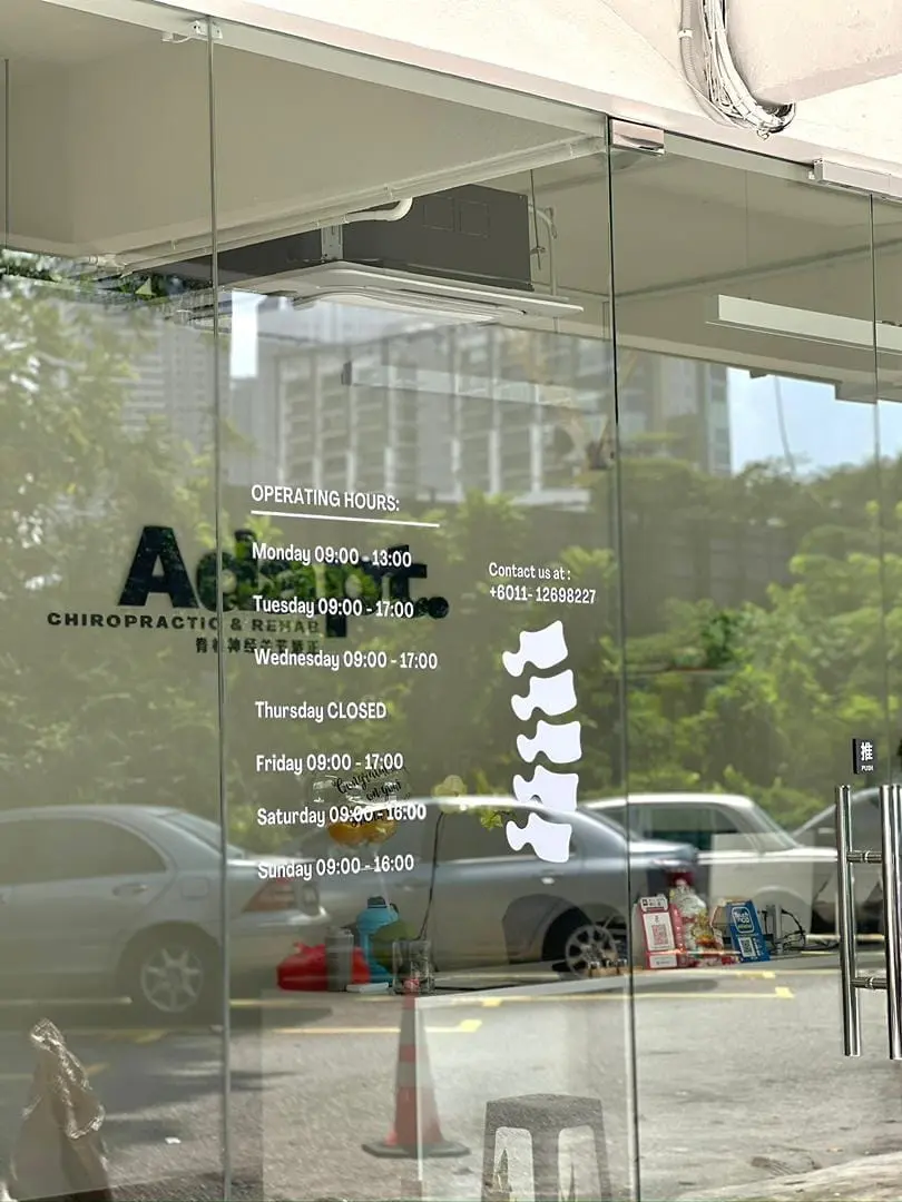 Adapt Chiropractic & Rehab entrance displaying clinic opening hours